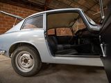 a car that is parked in a garage with its door open