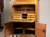 a wooden desk with a drawer and a book shelf