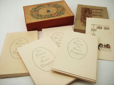 five old postcards sitting on top of each other on a table