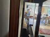 doorway view of a living room with a piano in the foreground