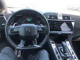 the interior of a car with a steering wheel and dashboard controls