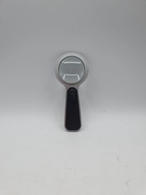 a close up of a magnifying glass on a white surface