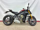 the motorcycle is parked in front of a white backdrop