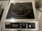 a stove top that is sitting on a table in a kitchen