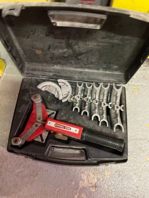 une boîte à outils contenant des outils, posée sur le sol