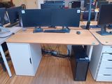 a computer desk with two monitors and a keyboard