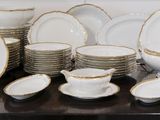 a lot of plates and bowls on the table