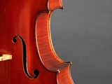 an old violin sitting on top of a wooden stand