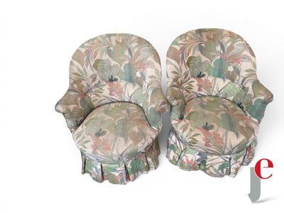 pair of upholstered chairs with floral upholstered covers on them