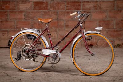 a bike that is parked in front of a brick wall