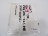 a plastic bag with a white t - shirt on top of it