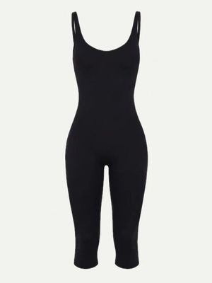 a woman in a black bodysuit with a black top and leggings