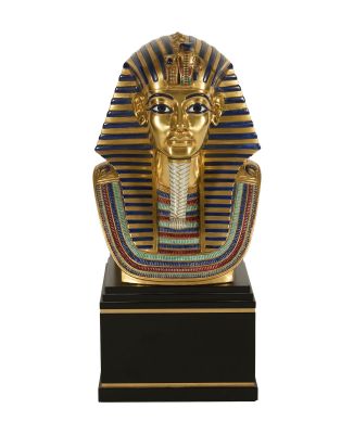 un masque de pharaon égyptien sur un socle noir rehaussé de touches dorées