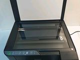 the printer is sitting on top of the desk with the screen open