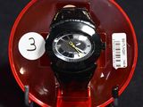 a black and red watch sitting on a red plate