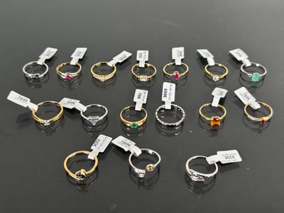 several different types of rings on a table with tags on them