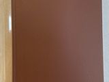 a brown book sitting on top of a white table next to a cup of coffee