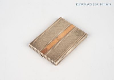 a silver and gold card case on a white surface