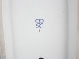 a white toilet with a blue spray painted on it