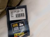 a label on the back of a jacket on a bed