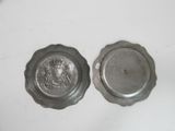 pair of silver plate with a lion head on the front and a silver plate with a lion head on the back