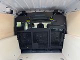a black cage in the back of a white van