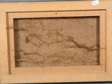 an old picture of a woman laying on a bed in a wooden frame