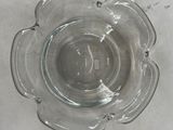 a clear glass bowl with a flower design on it