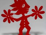a red sculpture of a boy with flowers in his hand