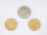 three different types of coins on a white surface