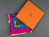 an orange box with two colorful handkerchiefs in it
