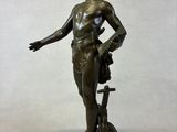 bronze statue of a man with a dog on a rock