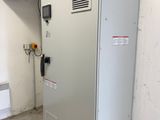 an image of a refrigerator in a room with a fan