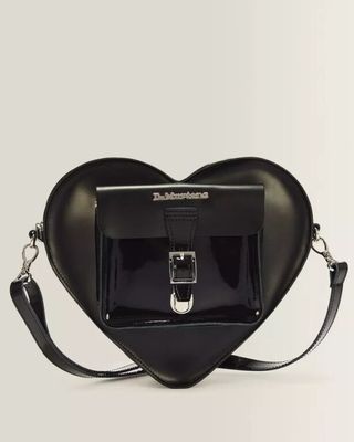 a black heart shaped bag with a metal buckle on a white background