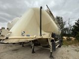 a boat that is sitting on a trailer in the dirt