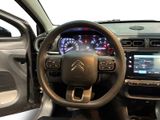 the interior of a car with a steering wheel and dashboard controls