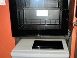 a small refrigerator and a mini fridge in a small room