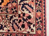 an antique persian rug on a white floor with a red and blue border