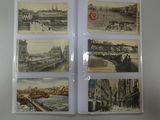 four old postcards of different cities on a table