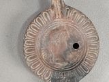a close up of a metal object on a white surface