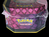 a box of pokemon trading card game items on a black background