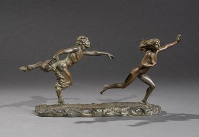 two bronze statues of a man and a woman on a rock