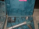 a blue box with tools inside of it on the floor