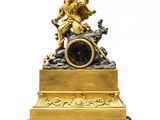 a gold clock with a statue on top of it