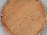 a wooden plate on a shelf on the wall
