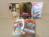 four nintendo wii games sitting on a couch