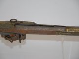 an old gun with a wooden handle on display in a museum
