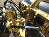 a close up of a tractor with a machine attached to it ' s back