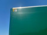 a large green box truck parked on the side of the road