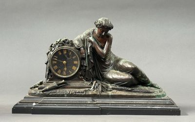 a statue of a woman with a clock on a table
